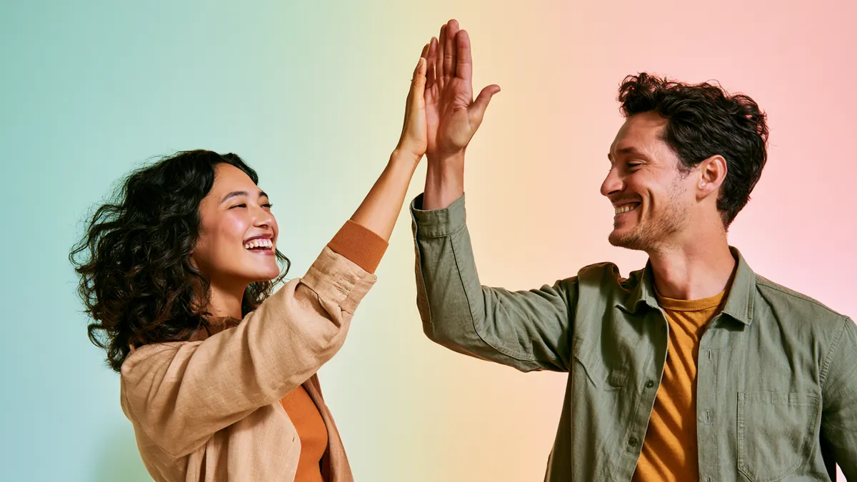 Two people high-fiving after completing a Happy Money loan request